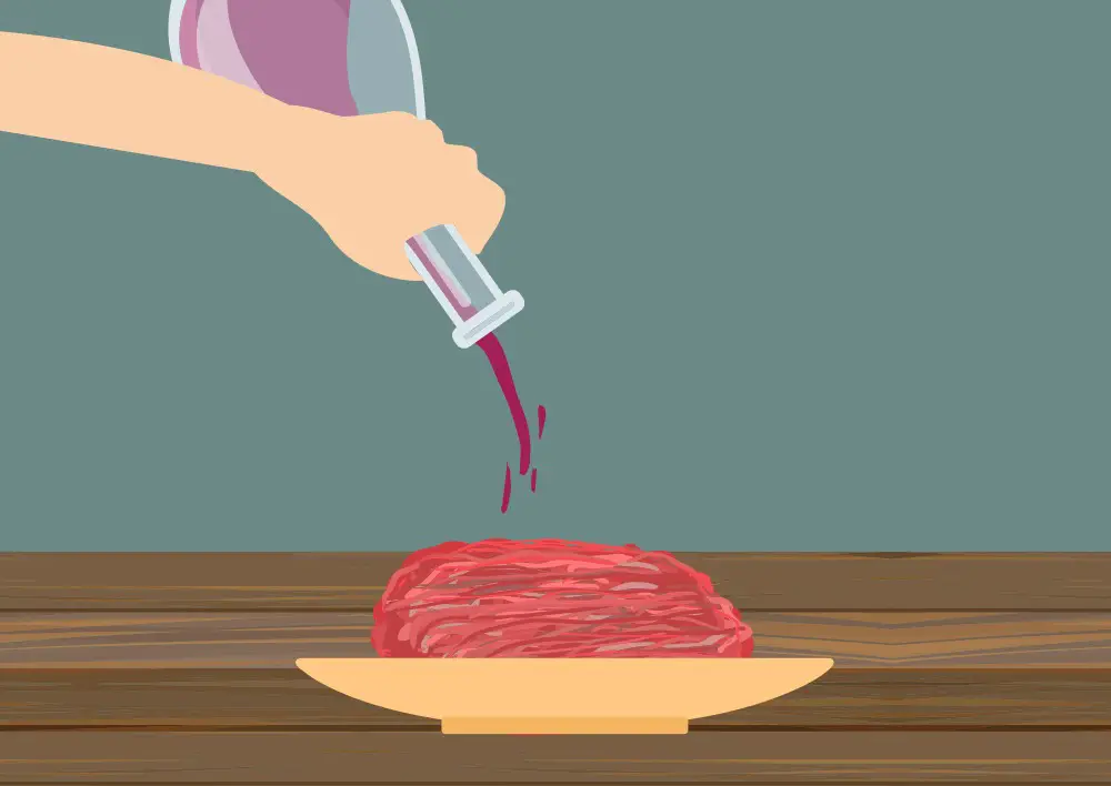 Pouring port over sausage meat