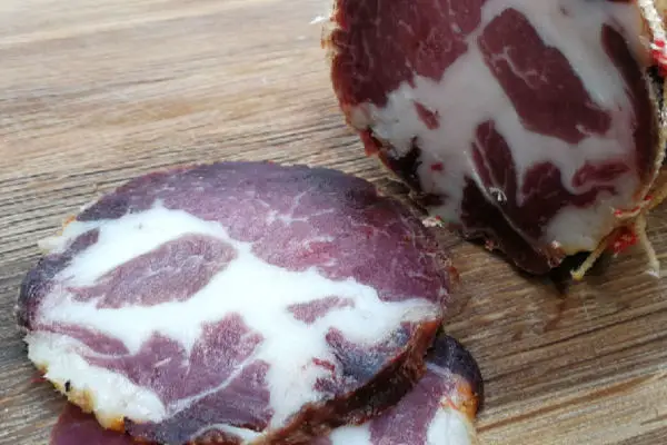 Sliced capicola showing the fat marbling