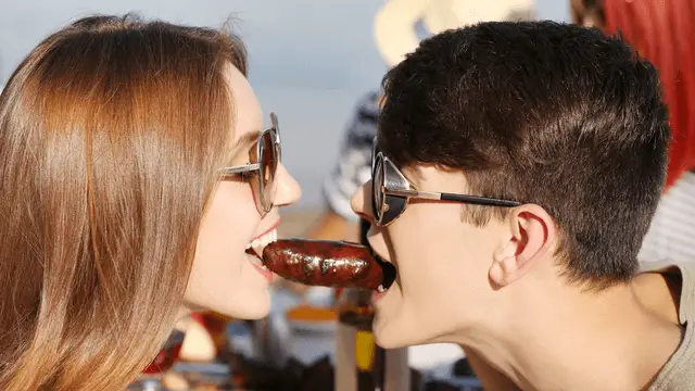 couple eating the same sausage
